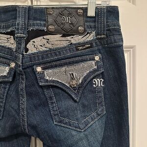 Stunning embellished “miss me” dark boot, cut jeans. Size 27.